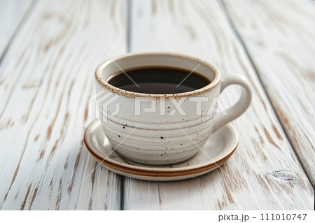Cup of aromatic black coffee on a white rustic wooden background 111010747
