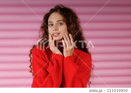 Young red haired woman doing face yoga facial gymnastics self massage and face building exercise 111010950