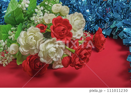 Bouquet of white and red roses on a red background 111011230