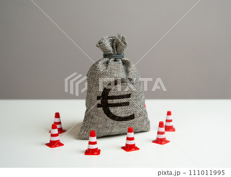 Euro money bag blocked by road cones. Suspicious funds with unknown sources. National money reserve. Freezing of accounts and sanctions on capital. Euro money bag blocked by road cones. Suspicious funds with unknown sources. National money reserve. Freezing of accounts and sanctions on capital. 111011995