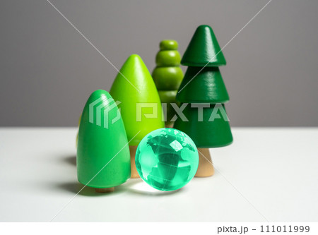 Forest and blue globe. Wooden tree figurines. Conservation of forests and nature reserves. Innovative technologies to reduce the impact on the environment. Environmental protection. Forest and blue globe. Wooden tree figurines. Conservation of forests and nature reserves. Innovative technologies to reduce the impact on the environment. Environmental protection. 111011999