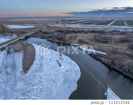 dusk over the South Platte River and plains in eastern Colorado in winter scenery, aerial view dusk over the South Platte River and plains in eastern Colorado in winter scenery, aerial view 111012588
