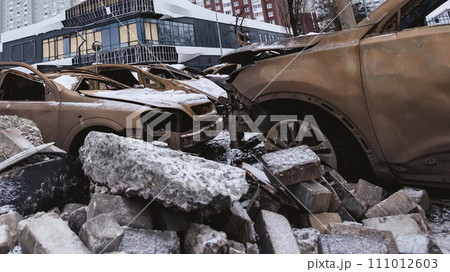 Kyiv, Ukraine - January 3, 2024: Burned civilians cars after a Russian's missiles attack Kyiv, Ukraine - January 3, 2024: Burned civilians cars after a Russian's missiles attack 111012603