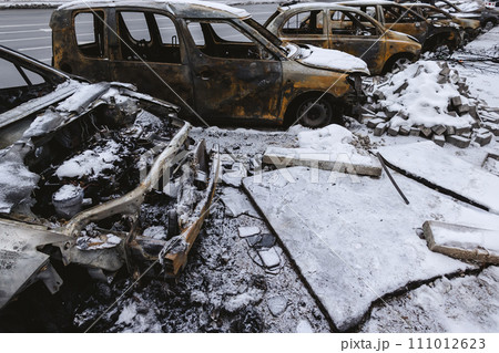 Kyiv, Ukraine - January 3, 2024: Burned civilians cars after a Russian's missiles attack Kyiv, Ukraine - January 3, 2024: Burned civilians cars after a Russian's missiles attack 111012623