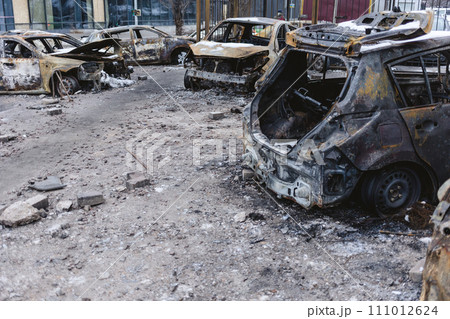 Kyiv, Ukraine - January 3, 2024: Burned civilians cars after a Russian's missiles attack Kyiv, Ukraine - January 3, 2024: Burned civilians cars after a Russian's missiles attack 111012624
