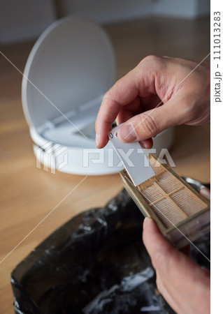 Cleaning the filter of the vacuum robot cleaner from dirt, close-up. 111013283