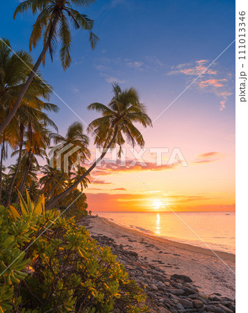 Tropical beach with soft sunrise or sunset tones and ocean in Maldives Tropical beach with soft sunrise or sunset tones and ocean in Maldives 111013346