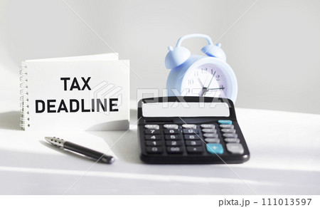 Notepad with text message TAX DEADLINE. Conceptual image Notepad with text message TAX DEADLINE. Conceptual image 111013597