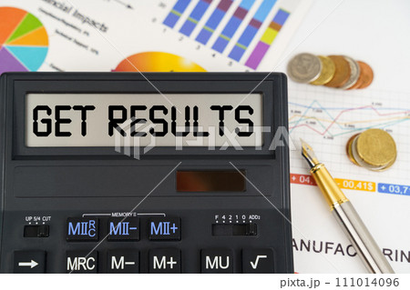 On the table are financial reports, coins and a calculator with the inscription - get results 111014096