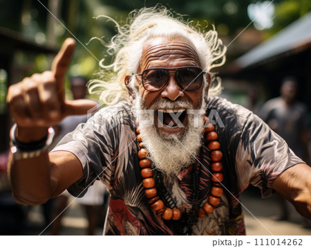 An energetic older Indian man with a beaming smile and animated gestures. 111014262