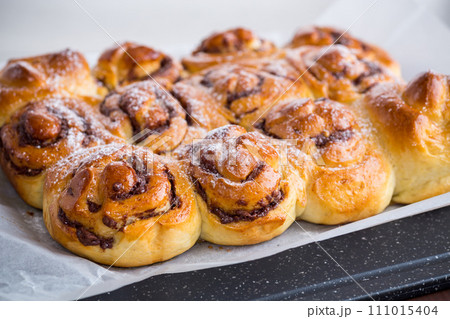 cooked baked sweet bun rolls with chocolate filling cooked baked sweet bun rolls with chocolate filling 111015404