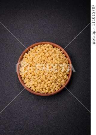 Delicious ditali pasta from durum wheat with salt and spices Delicious ditali pasta from durum wheat with salt and spices 111015787
