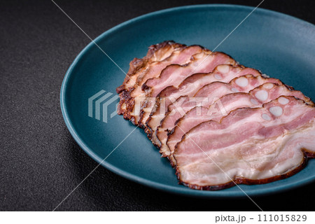 Delicious fresh pancetta or bacon with salt and spices cut into thin slices 111015829