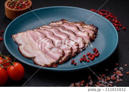 Delicious fresh pancetta or bacon with salt and spices cut into thin slices 111015832