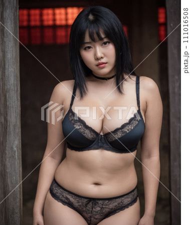 an asian woman in black lingerie posing for the camera 111016508