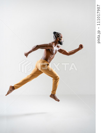 Shirtless muscular gay man running isolated on Shirtless muscular gay man running isolated on 111017987