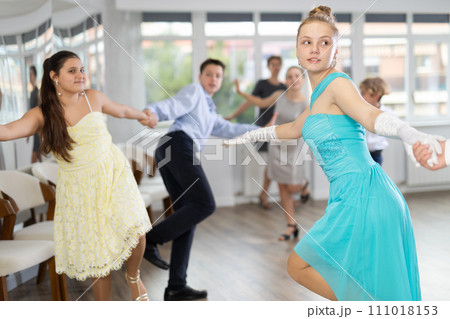 Group of festively dressed boys and girls dance twist dance Group of festively dressed boys and girls dance twist dance 111018153