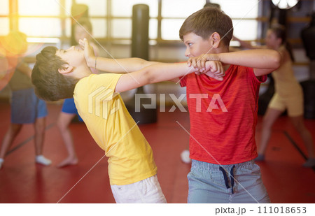 Two boys in pair practicing self-protection Two boys in pair practicing self-protection 111018653