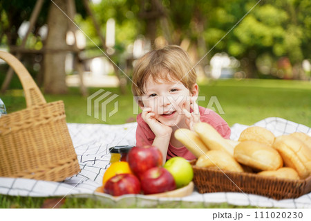 Happy family picnic in the park public on summer holiday.  Family boy relax and enjoying outdoor. 111020230
