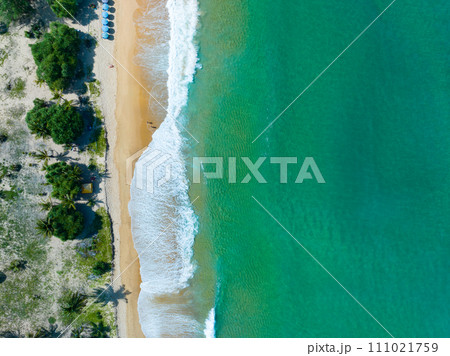 Aerial view of Waves crashing on sandy shore,Sea surface ocean waves background,Top view beach background 111021759