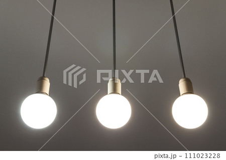 LED white bulbs hanging from the ceiling. Illumination technology. 111023228