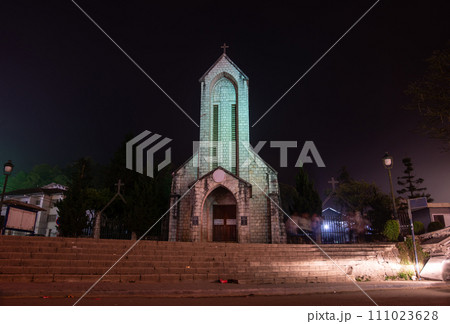 Night view of an iconic stone church of Sapa named Holy Rosary church the Gothic style church located in the heart of Sapa, Vietnam. Sapa is the resort town in Lao Cai province in Northwest Vietnam. 111023628