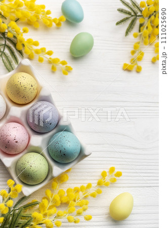 Colorful easter eggs  and mimosa flowers on wooden table. 111025690