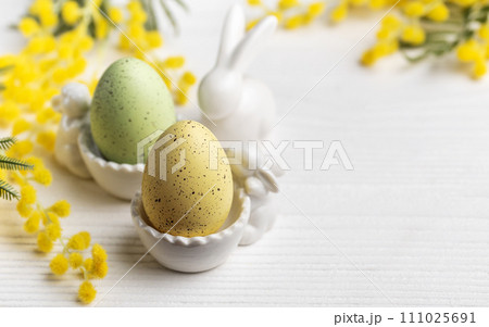 Colorful easter eggs  and mimosa flowers on concrete background 111025691