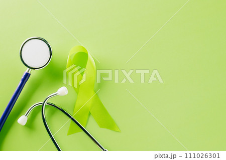 Green awareness ribbon and doctor stethoscope symbol of Gallbladder and Bile Duct Cancer month on green background with copy space, concept of medical and health care support, World bipolar day Green awareness ribbon and doctor stethoscope symbol of Gallbladder and Bile Duct Cancer month on green background with copy space, concept of medical and health care support, World bipolar day 111026301