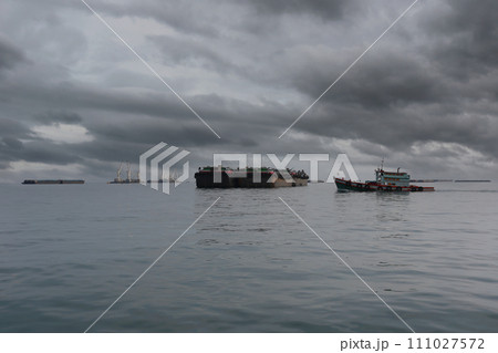Tug boats and cargo ships moored in the bay of Koh Sichang, Chonburi Province of Thailand. Tug boats and cargo ships moored in the bay of Koh Sichang, Chonburi Province of Thailand. 111027572
