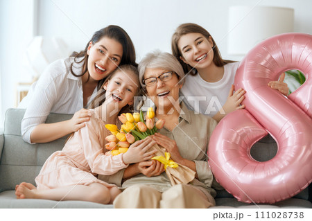 daughters, mom and granny with flowers 111028738