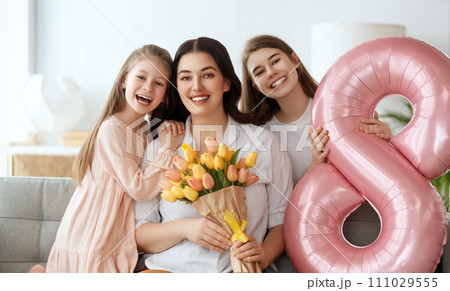 daughters and mom with flowers 111029555