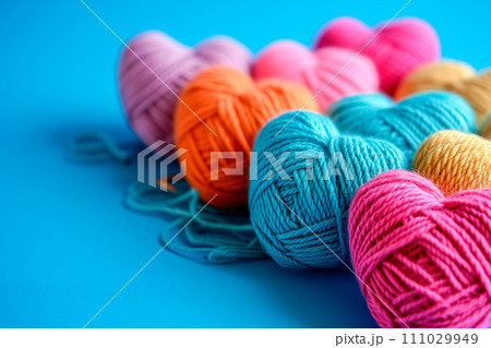 Poster or banner of colorful yarn hearts on surface on a blue background, Vibe of st. Valentine day and romantic 111029949