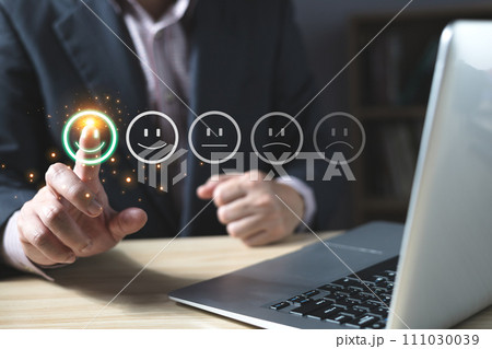 a businessman choose the virtual screen on the happy smile face icon to give satisfaction in service.rating very impressed.customer review service and Satisfaction concept 111030039