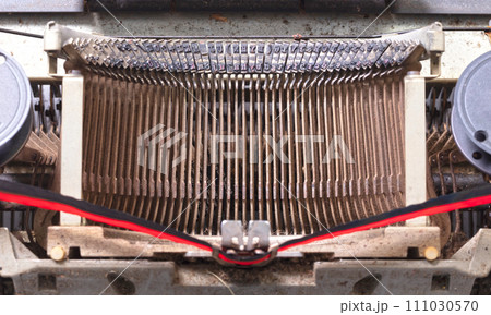 Broken metal typewriter, vintage object Broken metal typewriter, vintage object 111030570