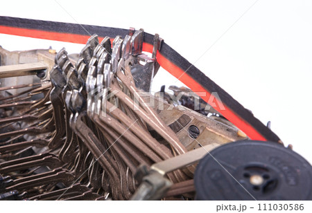 Broken metal typewriter, vintage object 111030586