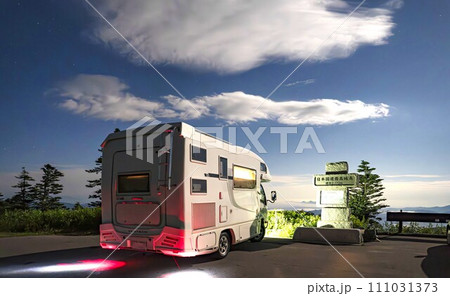 国道最高点の渋峠で星空を背景にするキャンピングカー 111031373