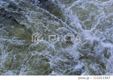 Close up detail of fierce white water river rapids from a clean deep green colored river forming a textured background Close up detail of fierce white water river rapids from a clean deep green colored river forming a textured background 111031987