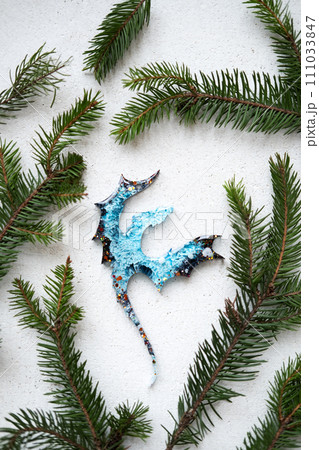 Resin Dragon Epoxy dragon ornament, symbolizing the upcoming 2024 Chinese Year of the Dragon in green pine tree, blending festive tradition with cultural significance. 111033847