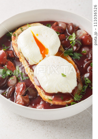 Burgundy Poached Egg in Red Wine Sauce on Toast Oeuf en Meurette closeup on the plate. Vertical 111036526