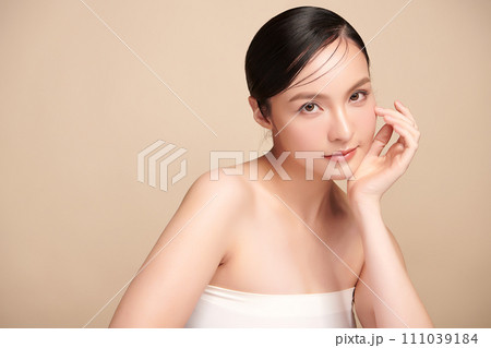Beautiful young asian woman with clean fresh skin on beige background, Face care, Facial treatment, Cosmetology, beauty and spa, Asian women portrait. 111039184