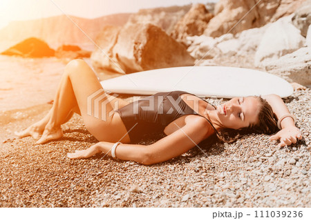 Woman sea sup. Close up portrait of happy young caucasian woman with long hair looking at camera and smiling. Cute woman portrait in bikini posing on sup board in the sea Woman sea sup. Close up portrait of happy young caucasian woman with long hair looking at camera and smiling. Cute woman portrait in bikini posing on sup board in the sea 111039236