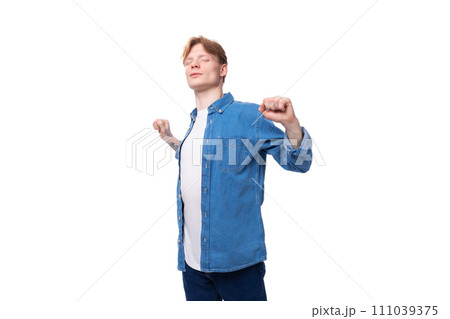young friendly man with red hair in a blue shirt and white t-shirt young friendly man with red hair in a blue shirt and white t-shirt 111039375