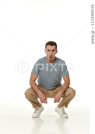 surprised guy looking at camera on white studio background 111040038