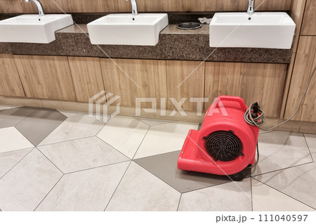 Floor dryer fan used in public washroom and toilet to dry the floor after washing and cleaning Floor dryer fan used in public washroom and toilet to dry the floor after washing and cleaning 111040597