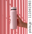 a hand holding a matte white water bottle . The bottle has a black ring near the cap,  Genearative AI 111041983