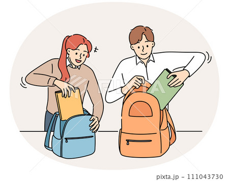 Smiling students pack backpacks in school 111043730