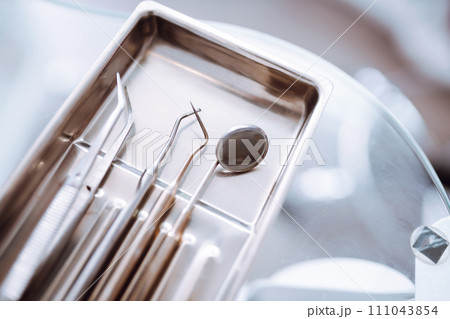 A set of sterile dental instruments for dental treatment. Dental care for people. 111043854