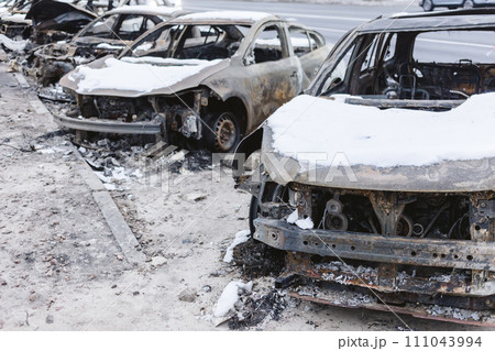 Kyiv, Ukraine - January 3, 2024: Burned civilians cars after a Russian's missiles attack Kyiv, Ukraine - January 3, 2024: Burned civilians cars after a Russian's missiles attack 111043994