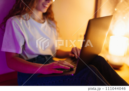 Young woman with laptop. Freelance or studying concept. Online training, shopping, blogging. 111044046